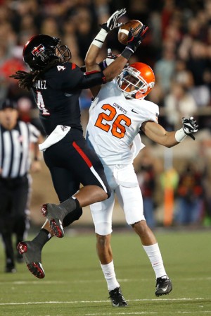 Texas Tech receiver Bradley Marquez and Oklahoma State cornerback Tyler Patmon compete for the ball on Saturday in Lubbock. Stephen Spillman | Associated Press