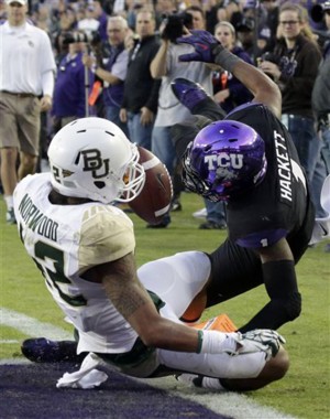 Baylor wide receiver Levi Norwood (42) scores a touchdown against TCU safety Chris Hackett (1) during the second half of an NCAA college football game on Saturday, Nov. 30, 2013, in Fort Worth, Texas. Baylor won 41-38. (AP Photo/LM Otero)