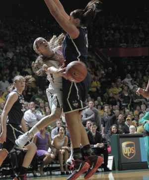 Senior guard Makenzie Robertson passes around a UConn defender during Baylor's 66-55 loss on Monday, January 13, 2014 at the Ferrell Center.   Travis Taylor | Lariat Photo Editor