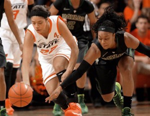 Oklahoma State forward Brittney Martin, left, and Baylor guard Odyssey Sims, right, chase after a loose ball during the first half of an NCAA college basketball game in Stillwater, Okla., Sunday, Jan. 26, 2014. (AP Photo/Brody Schmidt)