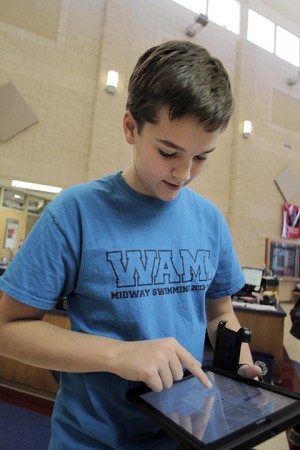 Midway High School freshman Quinn McGinty works on his new iPad  at Midway High School on Wednesday, January 15, 2013.  iPads were purchased for every student in the Midway Independent School District. Travis Taylor | Lariat Photo Editor