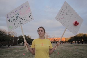 Tulsa, Okla. freshman Rachel Leland protests next to a pro-life display on Fountain Mall on Wednesday, January 22, 2014.  "We just thought it was appropriate to represent the other side of the debate," Leland said Travis Taylor | Lariat Photo Editor