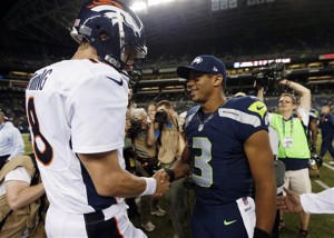 ADVANCE FOR WEEKEND EDITIONS, JAN. 25-26 - FILE - In this Aug. 17, 2013, file photo, Seattle Seahawks quarterback Russell Wilson (3) shakes hands with Denver Broncos quarterback Peyton Manning, left, after the Seahawks beat the Broncos 40-10 in preseason NFL football game  in Seattle. The two teams are slated to meet in Super Bowl XLVIII on Sunday, Feb. 2, 2014, in East Rutherford, N.J. (AP Photo/John Froschauer, File)