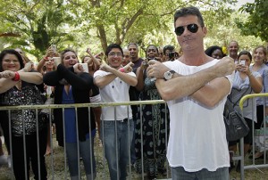 Simon Cowell's flashes an X as he arrives to judge auditions for the new Fox TV show "X Factor" on Tuesday, June 14, 2011 at the BankUnited Center in Coral Gables, Florida. (Al Diaz/Miami Herald/MCT)
