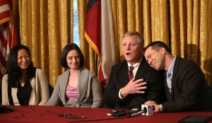 Gay couples from left, Cleopatra De Leon and Nicole Dimetman, and Mark Phariss and Victor Holmes, give a news conference in San Antonio on Wednesday, Feb. 26, 2014 after U.S. Federal Judge Orlando Garcia declared a same-sex marriage ban in deeply conservative Texas unconstitutional. (AP Photo/San Antonio Express-News, Jerry Lara)