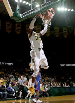 Senior forward Cory Jefferson dunks two points for the Bears at Tuesday's match against the Kansas Jayhawks. Jefferson had a total of 14 points, the highest scorer during the game. Carlye Thornton | Lariat Photographer