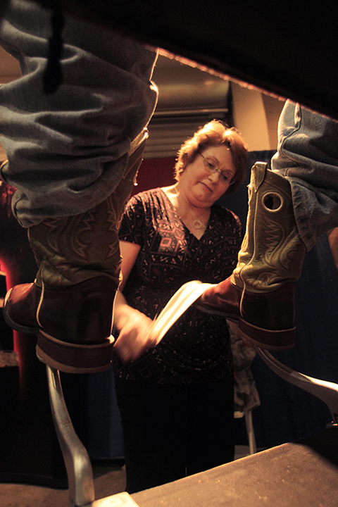 Donna Bennett of Arlington shines a pair of boots at the Mid Tex Farm and Ranch Show on Tuesday, February 4, 2014 at the Extraco Events Center.  The show, which features a variety of farm equipment and agricultural services,  continues tomorrow.     Travis Taylor | Lariat Photo Editor