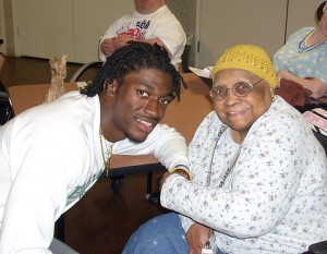 Baylor’s 2011 Heisman Trophy winner Robert Griffin III visits Emelda Edwards, a Waco nursing home client. Griffin will return to Waco in May to raise funds for Friends for Life, an organization that benefits the elderly and disabled in the area. Courtesy photo