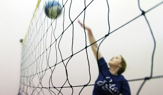 Austin freshman Alex Davis spikes the ball during a game of wallyball with friends at the Mclane Student Life Center on Wednesday.