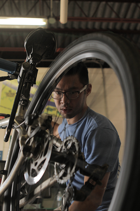 Ned Potithavoranant, 23, works on a bike at the bike shop at the Baylor Marina on Wednesday, February 19, 2014.  The bike shop is open from 3-6 Monday through Friday and services flat tires, brakes, gears, and cables.  The bike shop also tries to educate cyclists on how to repair bikes, Potithavoranant said.   Travis Taylor | Lariat Photo Editor