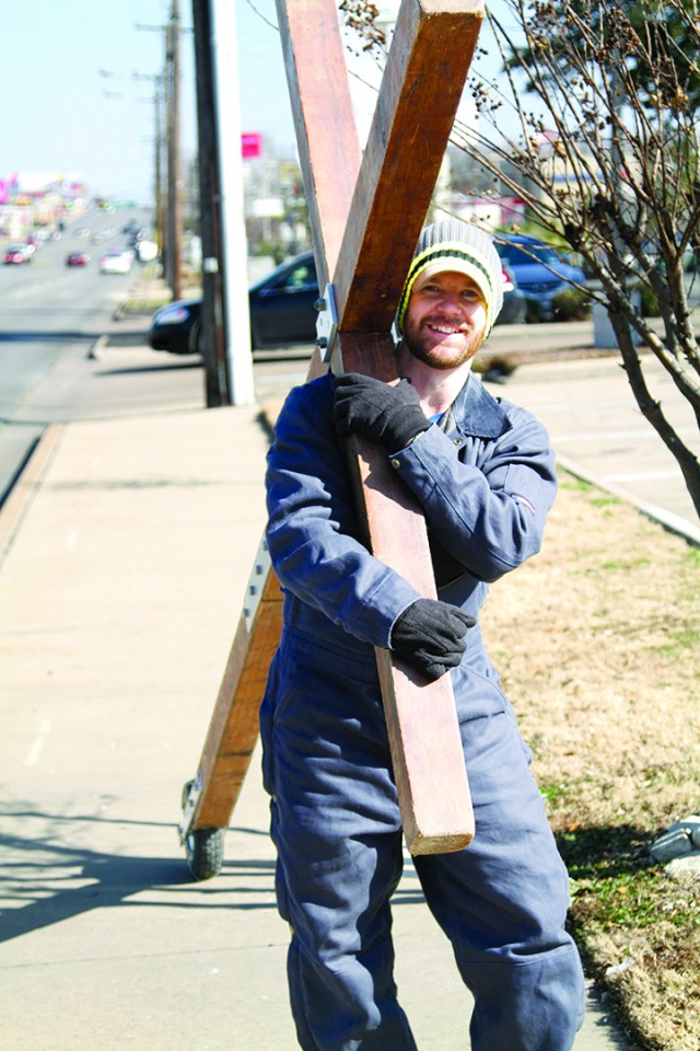 Eric Smith carries a cross down Valley Mills on February 12th, 2014. "I'm just out here to tell people how much God loves them," he smiled. Kevin Freeman | Lariat Photographer
