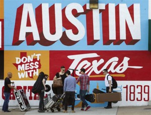 FILE - In this March 14, 2013 file photo, a band is on the move on the corner of Sixth Street and I-35 at South by Southwest in Austin, Texas.  iTunes is putting its stamp on South by Southwest, piggybacking on the annual event hosted by the city of Austin, Texas, with its own music festival. The company said Wednesday, Feb. 19, 2014,  it will debut its popular iTunes Festival, a free concert series held in London for the past seven years. While the London version is a 30-day event, the U.S. festival will feature five nights of rock, country, pop and hip-hop held at the ACL Live at the Moody Theater, where Austin City Limits is held. (AP Photo/Austin American-Statesman, Jay Janner)  AUSTIN CHRONICLE OUT, COMMUNITY IMPACT OUT, MAGS OUT; NO SALES; INTERNET AND TV MUST CREDIT PHOTOGRAPHER AND STATESMAN.COM