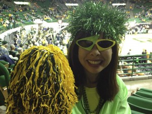 Van Davis shows her Baylor school spirit with a green pompom styled wig while attending a basketball game (above) and her bright pink wig (left). Davis is known for the many colorful wigs she can be seen sporting around campus and at Baylor sporting events. Courtesy Photo