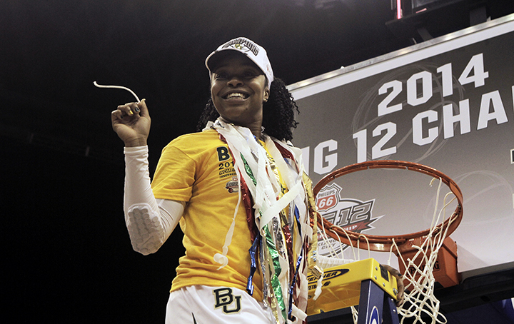 Senior guard Odyssey Sims cuts down the net after defeating West Virginia 74-71 and winning the Big 12 Championship in Oklahoma City on Monday, March 10, 2014.  Sims finished the game with 19 points and four rebounds.File Photo