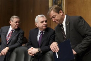 In this Feb. 27, 2014, file photo, Sen. Jack Reed, D-R.I., center, confers with Sen. Dean Heller, R-Nev., right, with Sen. Robert Menendez, D-N.J., at far left, as members of the Senate Banking Committee gather for an appearance by Janet Yellen on Capitol Hill in Washington. One partisan election-year battle that senators seem likely to resolve when they return from recess later this month is the fight over renewing expired benefits for the long-term unemployed. Reed, a leading bargainer, said the March 13 agreement would help families and "provide a little certainty to families, business and the markets that Congress is capable of coming together to do the right thing."  (AP Photo/J. Scott Applewhite, File)