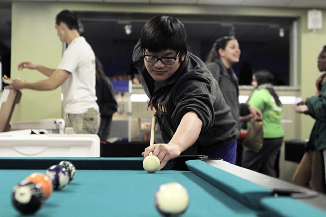 Spring junior Phil Lee takes aim during a game of pool at Midterm Madness, an event hosted by the Baylor Student Activities Union Board on Tuesday at the Bill Daniel Student Center.  Students were offered free food and bowling, as well as a break from studying for midterms.