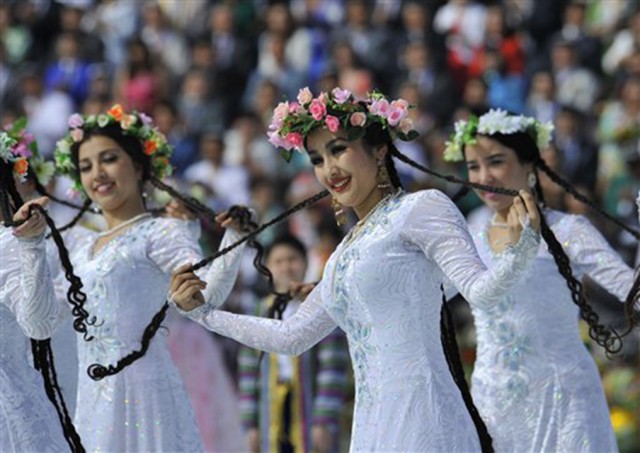 Uzbek dancers in folk costumes perform during the festivities marking the Navruz holiday in Tashkent, Uzbekistan. Navruz (“New Year”) dates back to ancient Iranian and Central Asian fire-worshippers who celebrated the spring equinox with dances and ritual food.