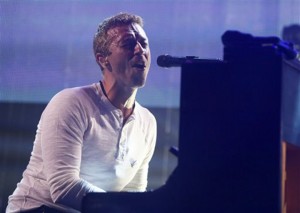 This March 11, 2014 file photo shows Coldplay's Chris Martin performing at the iTunes Festival during the SXSW Music Festival in Austin, Texas. Martin is bringing his expertise to NBCís music competition show ìThe Voice.î The network said Martin will participate in the ìbattlesî round that begins on March 31, advising singers on vocal technique and stage presence. (Photo by Jack Plunkett/Invision/AP, File)