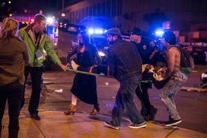 A bystander and a police officer tend to a man who was struck by a vehicle on Red River Street in downtown Austin at South by Southwest on Wednesday. Sandy Thuy, the third crash victim, died Monday from injuries sustained when she was runover outside The Mohawk music club