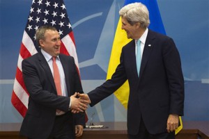 U.S. Secretary of State John Kerry, right, shakes hands with Ukrainian Foreign Minister Andriy Deshchytsia before their meeting at NATO Headquarters in Brussels, Tuesday April 1, 2014. (AP Photo/Jacquelyn Martin, Pool)