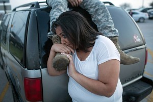 Lucy Hamlin and her husband, Spc. Timothy Hamlin wait for permission to re-enter the Fort Hood military base, where they live, following a shooting on base on Wednesday, April 2, 2014, in Fort Hood, Texas. One person was killed and 14 injured in the shooting, and officials at the base said the shooter is believed to be dead. The details about the number of people hurt came from two U.S. officials who spoke on condition of anonymity because they were not authorized to discuss the information by name. (AP Photo/Tamir Kalifa)