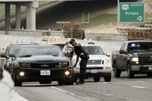 Police Officers direct traffic just outside of Fort Hood's Bernie Beck Gate Entrance on Wednesday, April 2. 