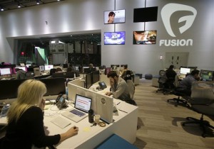 In this Monday, Oct. 14, 2013 file photo, workers are shown in the Fusion network's warehouse-turned-news hub known as Newsport, in Doral, Fla. Hispanic content became the buzzword for media companies in 2010, when the U.S. Census confirmed Latinos make up 17 percent of the U.S. population and would likely remain the fastest growing demographic for years to come. Since then, more than half a dozen news websites and networks have sprouted up targeting the nation’s 55 million Latinos. (AP Photo/Wilfredo Lee)
