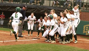 Senior first baseman Holly Holl runs to home plate to celebrate with teammates after hitting a home run at Getterman Stadium. Kevin Freeman | Lariat Photographer