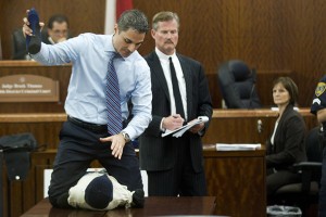 Prosecutor John Jordan does a crime scene demonstration, using a dummy, during the trial against Ana Trujillo  Tuesday, April 1, 2014, in Houston. Trujillo, 45, is charged with murder, accused of killing her 59-year-old boyfriend, Alf Stefan Andersson with the heel of a stiletto shoe, at his condominium in June 2013. Defense attorney Jack Carroll, center, and crime scene investigator Christopher Duncan are shown in the background. (AP Photo/Houston Chronicle, Brett Coomer)