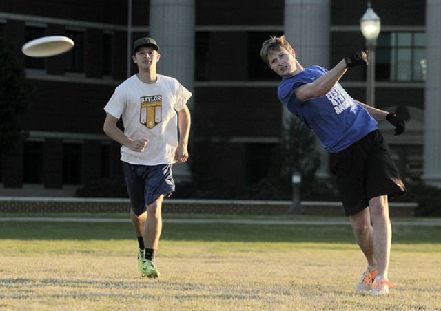 Shreveport, La., senior Dylan Greenleaf pulls the disc to the other team as The Woodlands junior Eric VerPloeg watches on during a pick up Ultimate frisbee game on Tuesday on the BSB fields. 