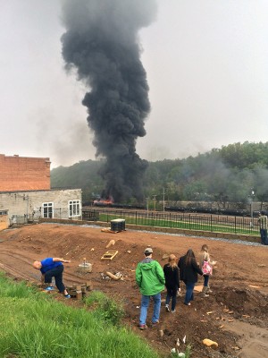 Smoke rises after several CSX tanker cars carrying crude oil derailed on Wednesday in Lynchburg, Va. Authorities evacuated numerous buildings Wednesday after the derailment.