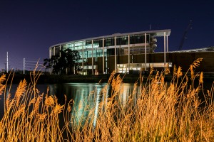 McLane Stadium glows on the Brazos Rivers amid construction on April 15.
