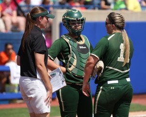 Assistant Baylor Softball Coach Britni Sneed-Newman meets with catcher Clare Hosack and pitcher Whitney Canion at the Women's College World Series in Oklahoma City on May 29, 2014.