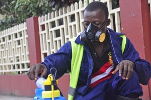 An employee of the Monrovia City Corporation mixes disinfectant before spraying it on the streets in a bid to prevent the spread of the deadly Ebola virus, in the city of Monrovia, Liberia, Friday, Aug. 1, 2014. Abbas Dulleh | Associated Press