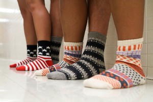 Panama City, Fla. junior Dannielle Perez, Kansas City, Kan. junior Jack Steadman and Mustang, Okla. sophomore Micaela Fox show off some of their Jungle Socks styles. Jungle Socks is a company that gives a pair of socks to a person in need per sock bought buy a consumer.Carlye Thornton | Lariat Photo Editor
