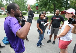 Michael Ingram, of Phoenix, left, and other volunteers with Black Lives Matter and Hands Up United gather near the home of St. Louis County Prosecuting Attorney Robert P. McCulloch while canvassing neighborhoods in efforts to inform people why they think McCulloch should be removed from the Michael Brown case in Kirkwood, Mo., Saturday, Aug. 30, 2014. Michael Brown, an unarmed black 18-year-old was fatally shot Aug. 9 by a white police officer.AP Photo | Roberto Rodriguez