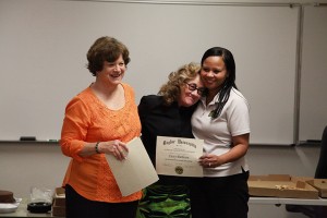 Dr. Sara Stone, journalism, public relations and new media department chair, and Dr. Mia Moody-Ramirez, associate professor of journalism, present Dr. Cassy Burleson with an award for having outstanding course speakers.Jon Platt | Lariat Reporter