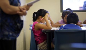 In this Wednesday, Sept. 10, 2014 photo, elementary aged children talk about a short story in Spanish during a class at the Karnes County Residential Center, a temporary home for immigrant women and children detained at the border in Karnes City, Texas.Eric Gay | Associated Press