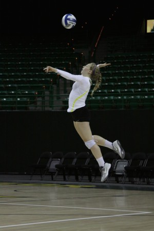 Freshman libero Jana Brusek (3) makes a serve at Tuesday’s game vs. Rice at the Ferrell Center. The Bears took a 4-set win over the Owls.Eric Vining | Web Editor