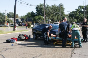 A student gets loaded into an ambulance following the collision of a car and moped. Drivers are encouraged to use caution and share the road with motorcyclists, and cyclists should take precautions to make themselves visible to drivers.Carlye Thornton | Lariat Photo Editor