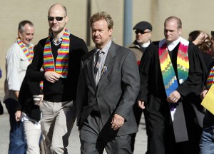 In a Oct. 22 file photo, the Rev. Frank Schaefer, center, and his son, Tim Schaefer, second from left, walk to a meeting of the Judicial Council.Associated Press