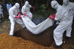 A burial team in protective gear buries a person suspected to have died of Ebola in Liberia. Even as Liberians get sick and die of Ebola, many beds in treatment centers are empty because of governemt orders that the bodies of all suspected Ebola victims be cremated. This violates Liberian values and cultural practices and has so disturbed people that the sick are often being kept at home and, if they die, are being secrety buried, increasing infection risk.  Associated Press