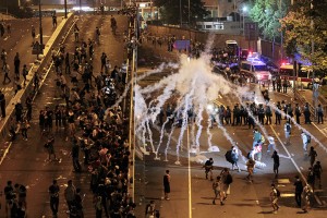 Riot police fire tear gas on student protesters occupying streets surrounding the government headquarters on Monday in Hong Kong.Associated Press