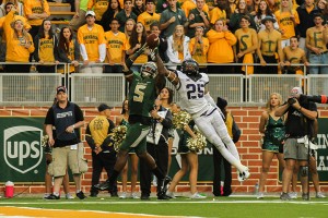 Senior wide receiver Antwan Goodley (5) catches the ball through TCU cornerback Kevin White’s hands for a touchdown in the fourth quarter. Baylor beat the Horned Frogs 61-58 to move to No. 4 in the nation and to take sole possession of first place in the Big 12.Kevin Freeman | Lariat Photographer