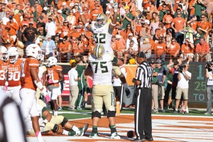 Sophomore running back Shock Linwood is hoisted into the air by senior right tackle Troy Baker after scoring a touchdown. The Bears beat Texas 28-7 on Saturday at Darrell K Royal-Memorial Stadium in Austin.  Skye Duncan | Lariat Photographer