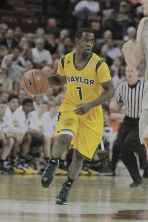 Senior point guard Kenny Chery dribbles the ball up the court during Baylor’s 74-69 loss to Texas on Feb. 26 at the Erwin Center in Austin. Chery is one of two seniors this year for Baylor basketball. Lariat File Photo