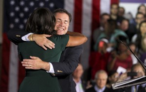 First lady Michelle Obama gets a hug from Iowa Democratic Senate candidate Bruce Braley Tuesday during a rally at the University of Iowa, in Iowa City, Iowa.Associated Press