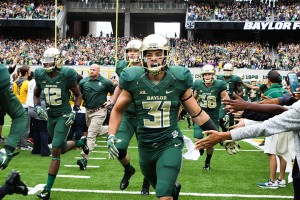 Sophomore running back Silas Nacita (31) runs out onto the field before Baylor’s game against TCU on Oct. 11. The Bears will continue conference play against West Virginia on Saturday.Carlye Thornton | Lariat Photo Editor