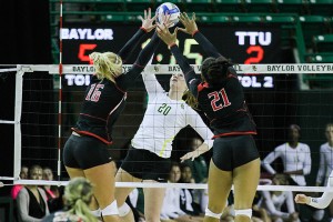 Junior middle hitter Adrien Richburg is blocked at the net by two Texas Tech defenders. Baylor dropped a close match to Texas Tech 3-1 on Wednesday night. Kevin Freeman | Lariat Photographer