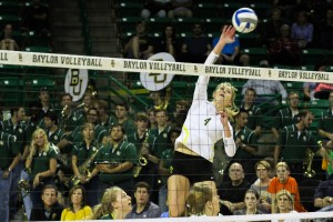Sophomore outside hitter Katie Staiger (4) goes up for a kill against West Virginia on Oct. 22. The Bears lost 3-1 at the Ferrell Center in Waco. Kevin Freeman | Lariat Photographer